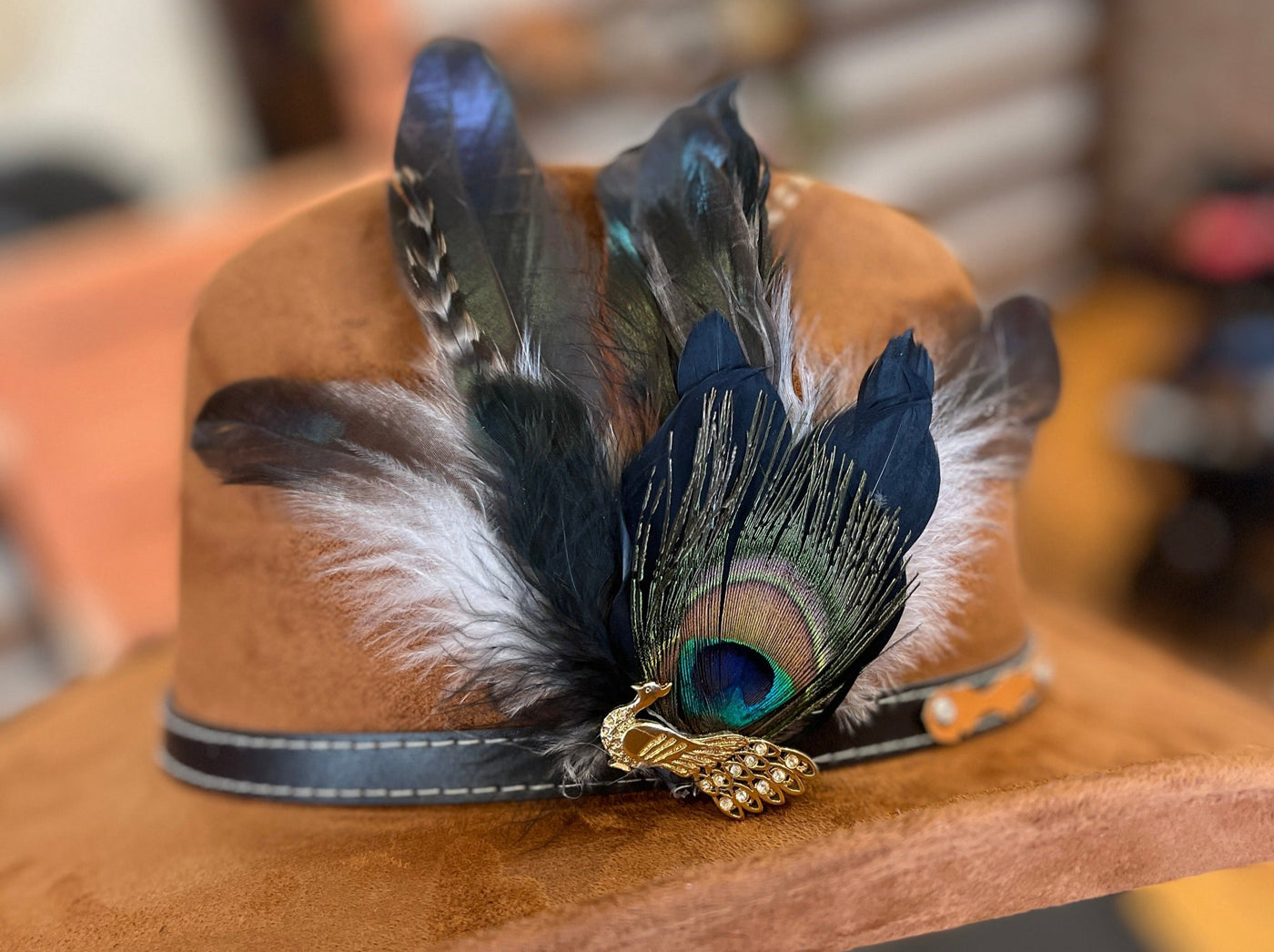 gold peacock broach with peacock feather