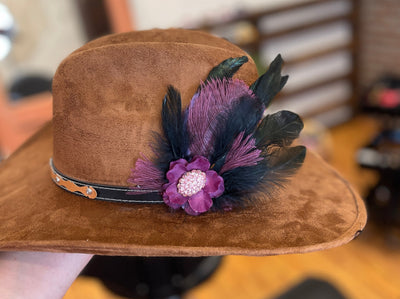 purple flower with pink broach 