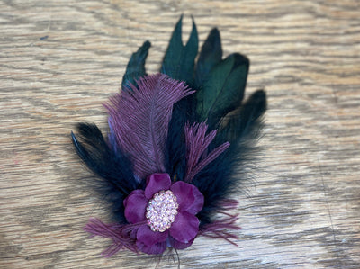 purple flower with pink broach 