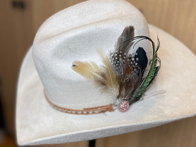 curled peacock feather with pink diamond broach